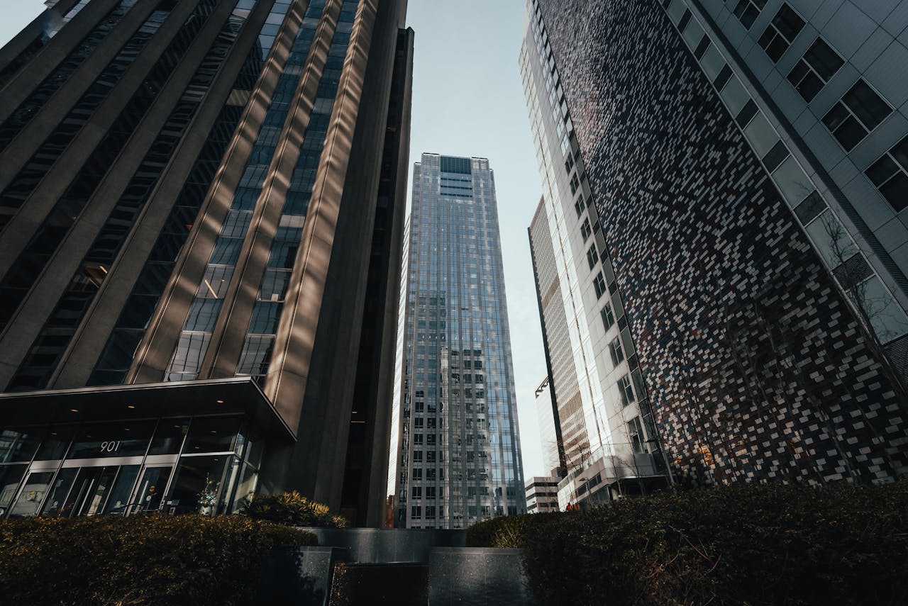 A stunning view of modern skyscrapers reaching up to a clear blue sky in an urban environment.