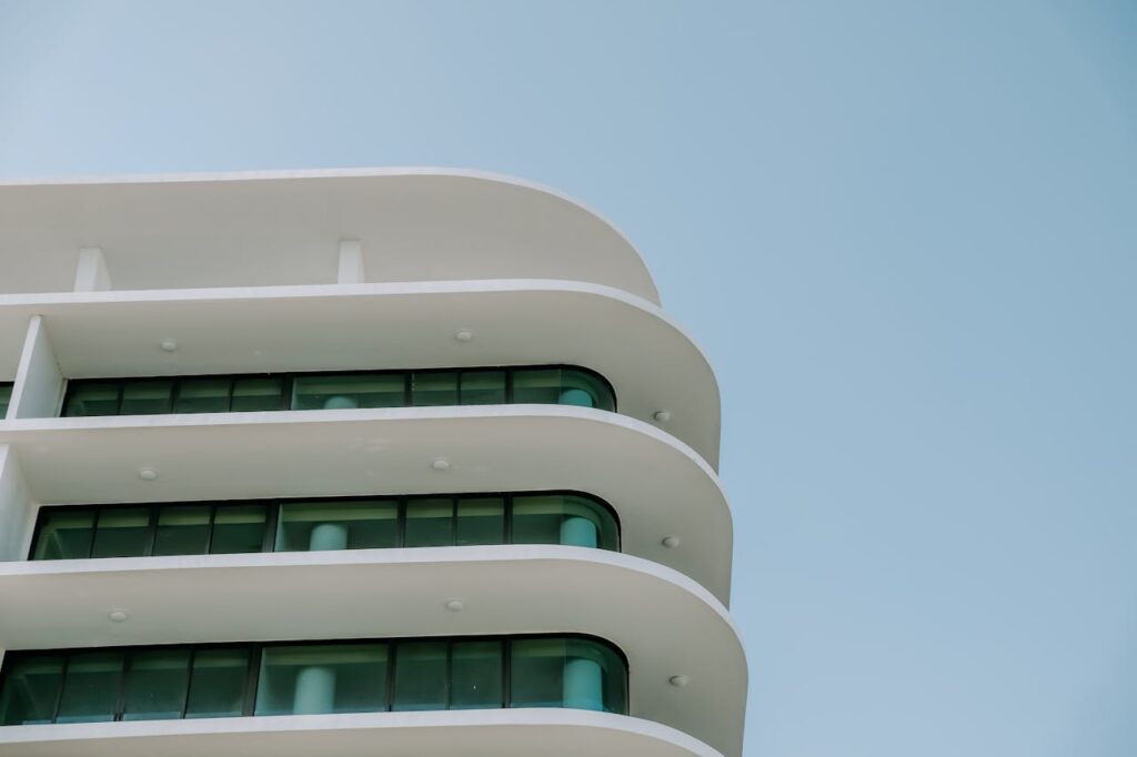 Close-up of a modern architectural building facade with curved balconies and glass windows.